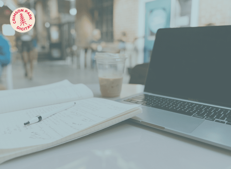 Computer with notebook.