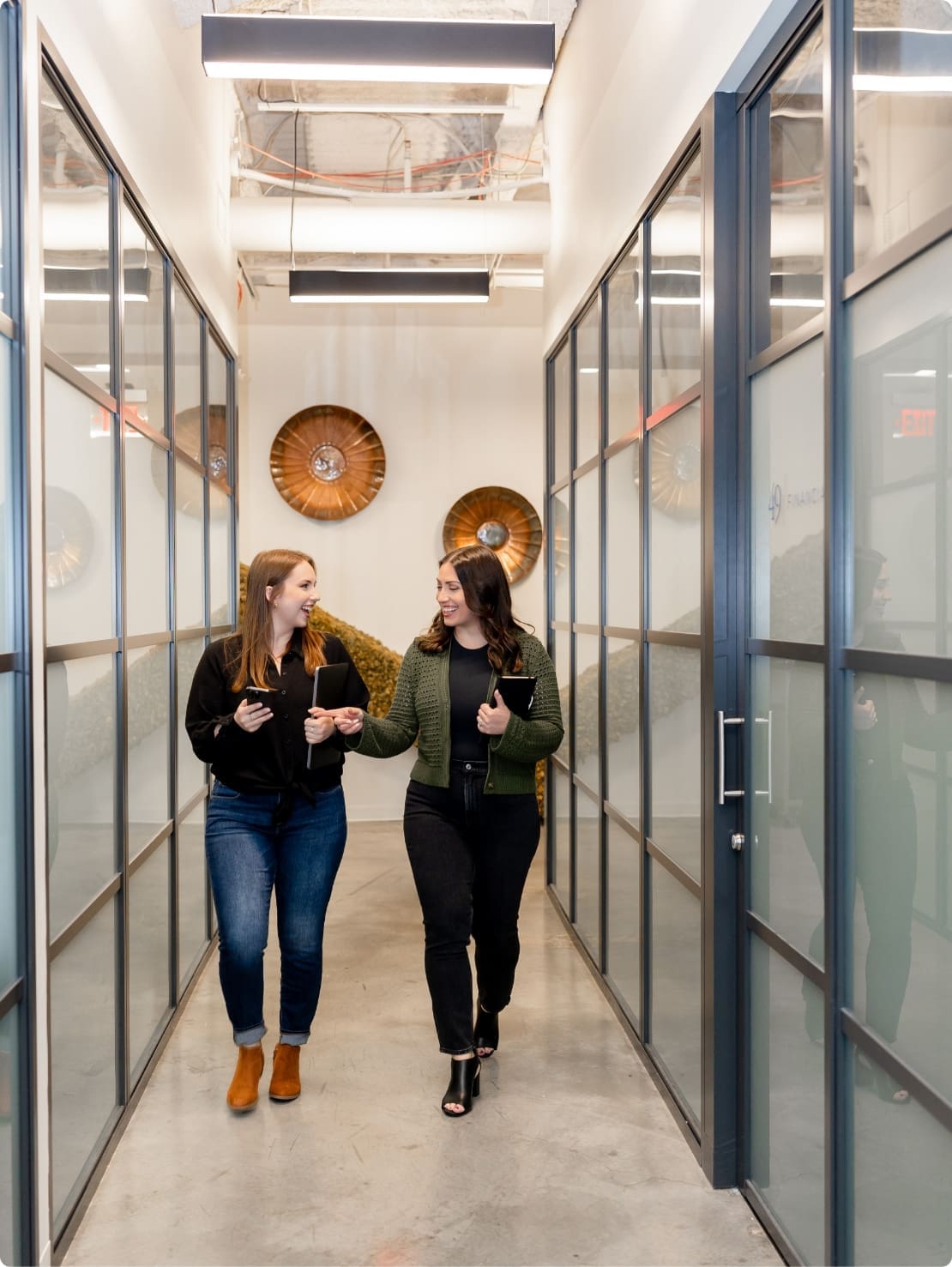 Two Crimson Park employees walking down an office hallway