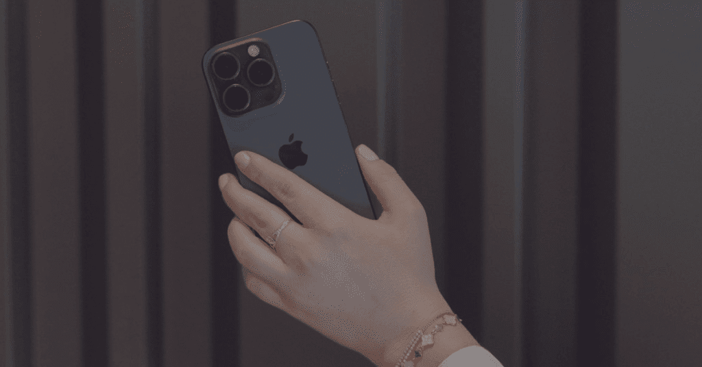 Hand holding a phone, illustrating the importance of using storytelling in social media.